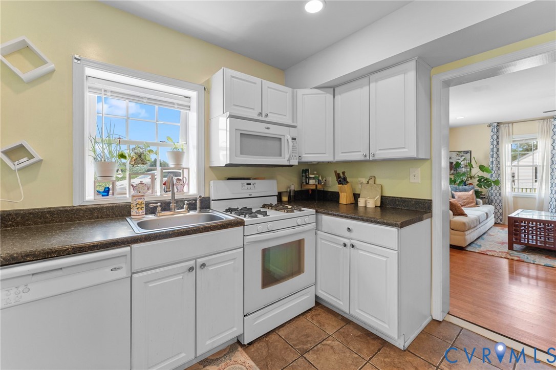 110 Hampton Road Dunnsville, VA 22454 - Photo 8 of 40 a kitchen with white cabinets and white appliances