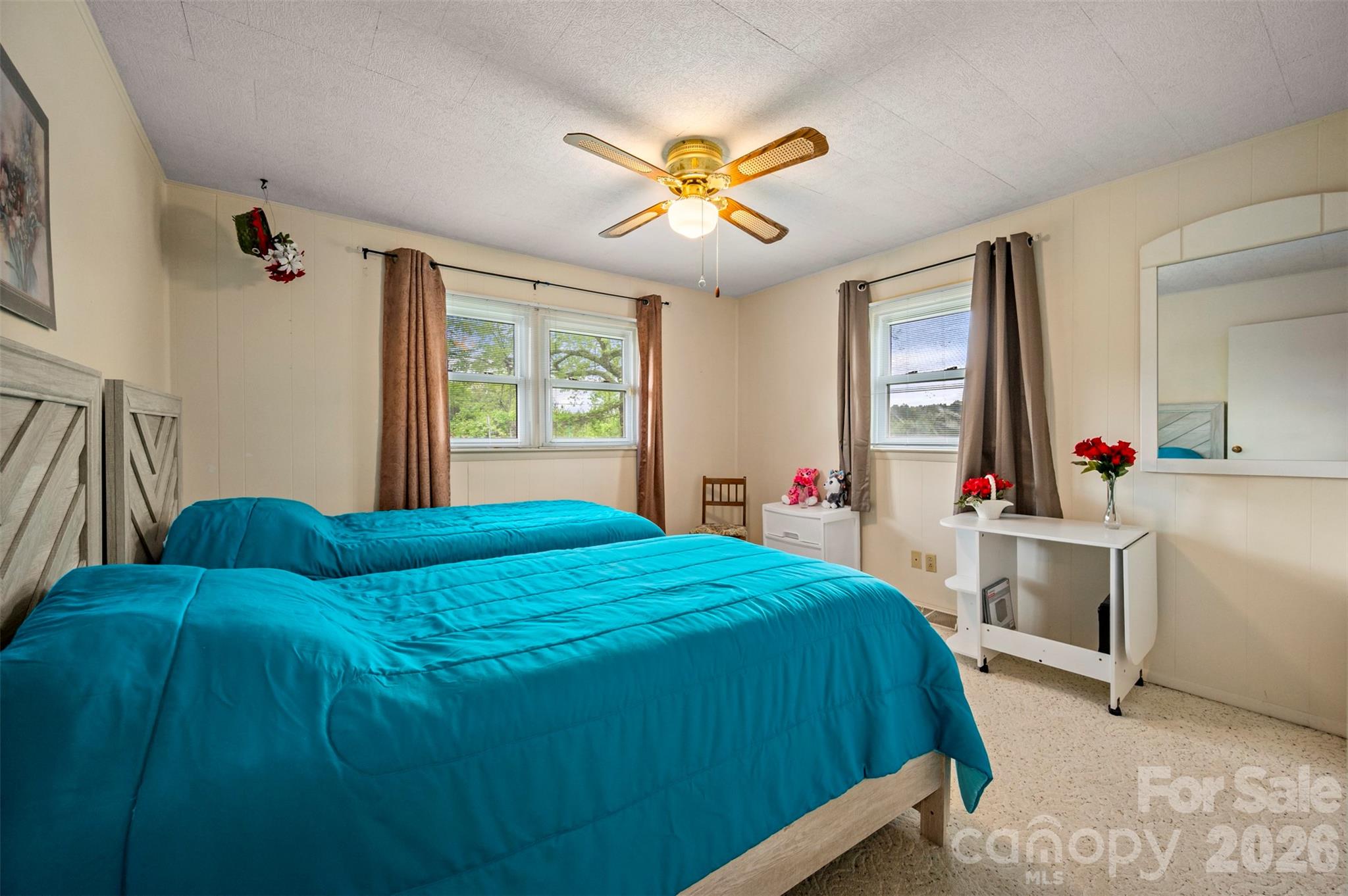 4665 Highway 9 Mill Spring, NC 28756 - Photo 16 of 46 a bedroom with a bed and a chandelier