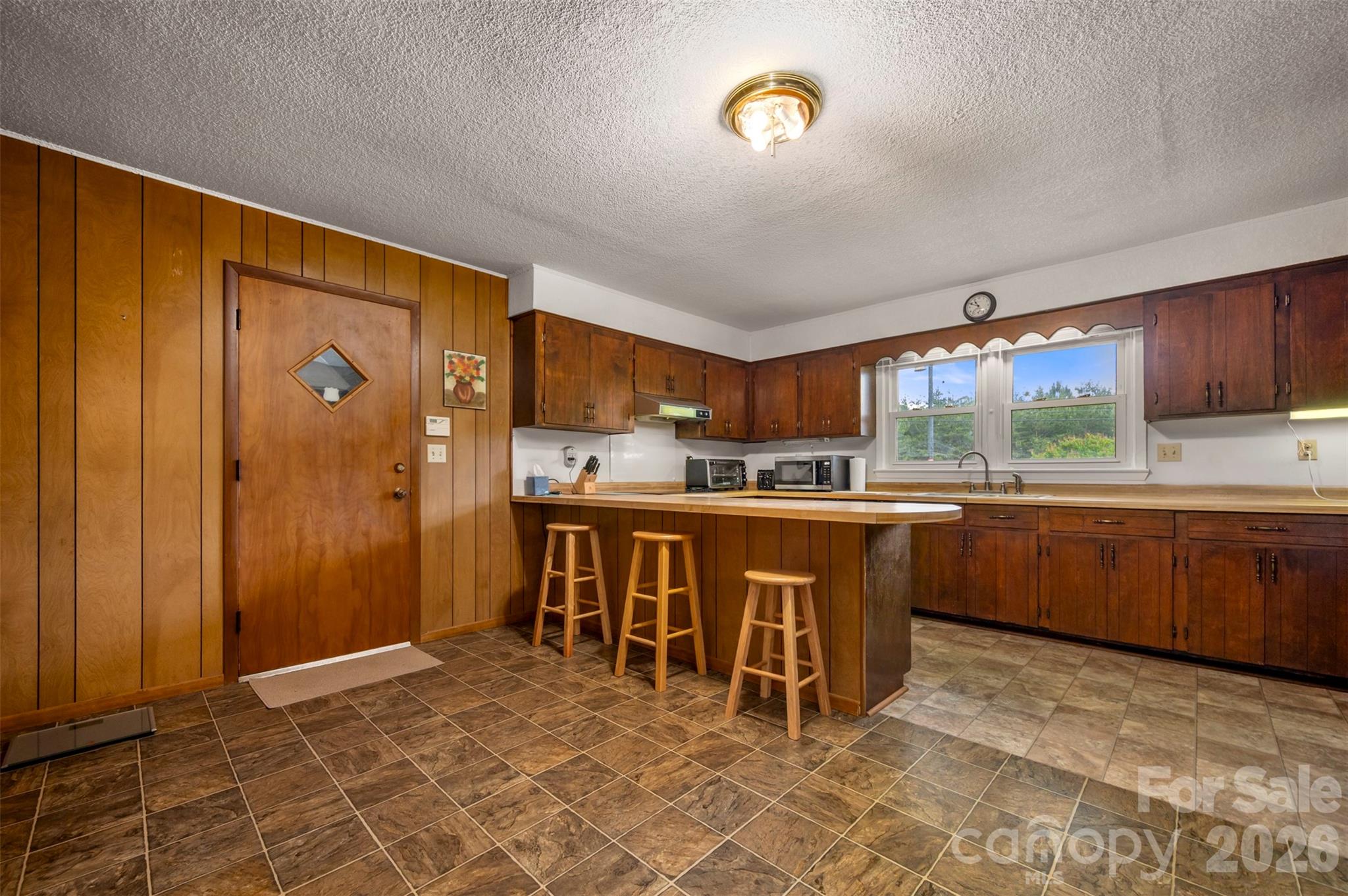 4665 Highway 9 Mill Spring, NC 28756 - Photo 8 of 46 a kitchen with a sink refrigerator and cabinets