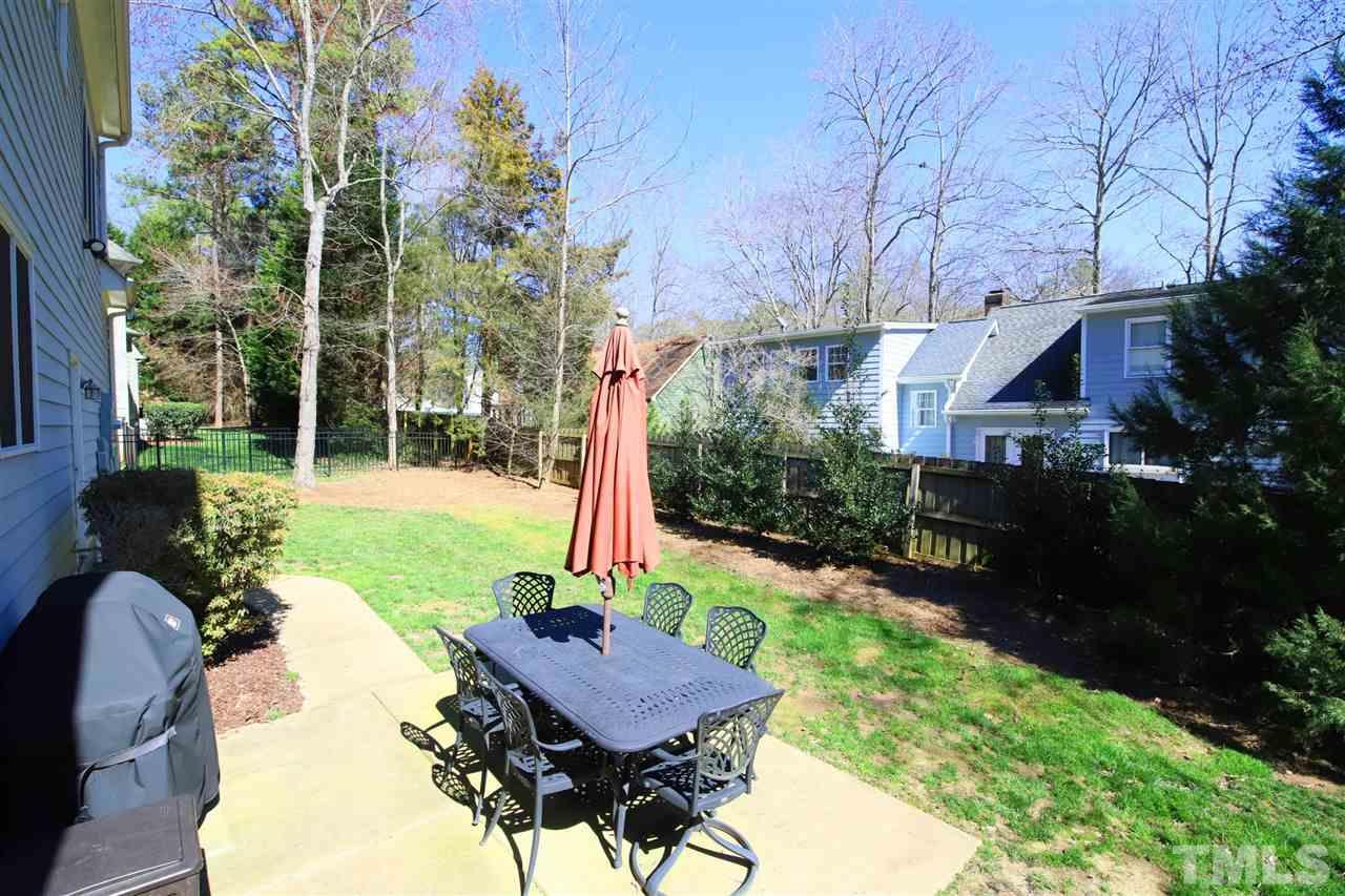 5706 Belmont Valley Court Raleigh, NC 27612 - Photo 4 of 6 a view of a chairs and table in backyard