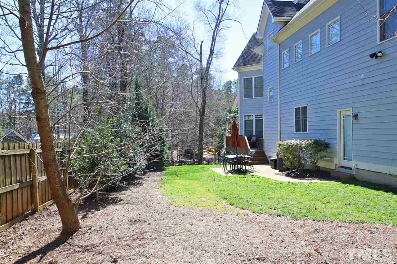 5706 Belmont Valley Court Raleigh, NC 27612 - Photo 5 of 6 a view of a house with a yard and pathway