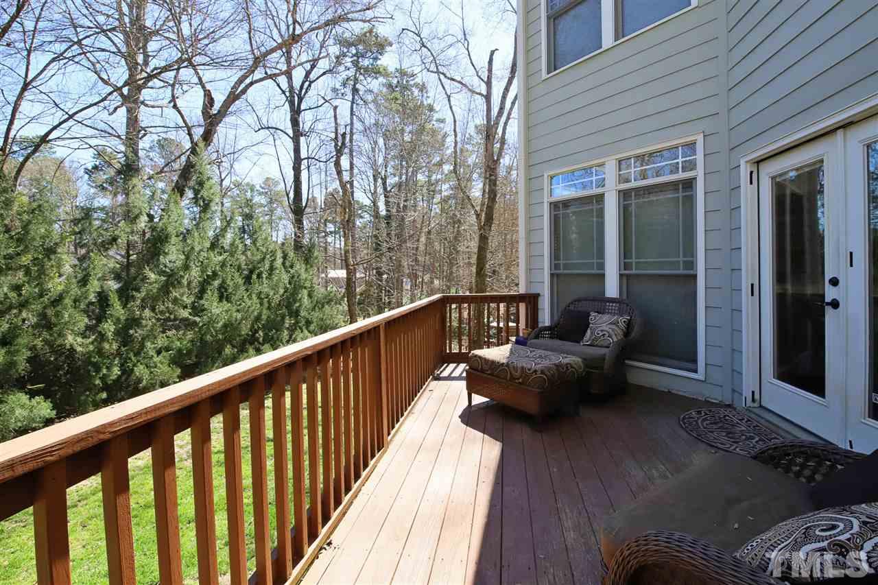 5706 Belmont Valley Court Raleigh, NC 27612 - Photo 6 of 6 a balcony with wooden floor and outdoor seating