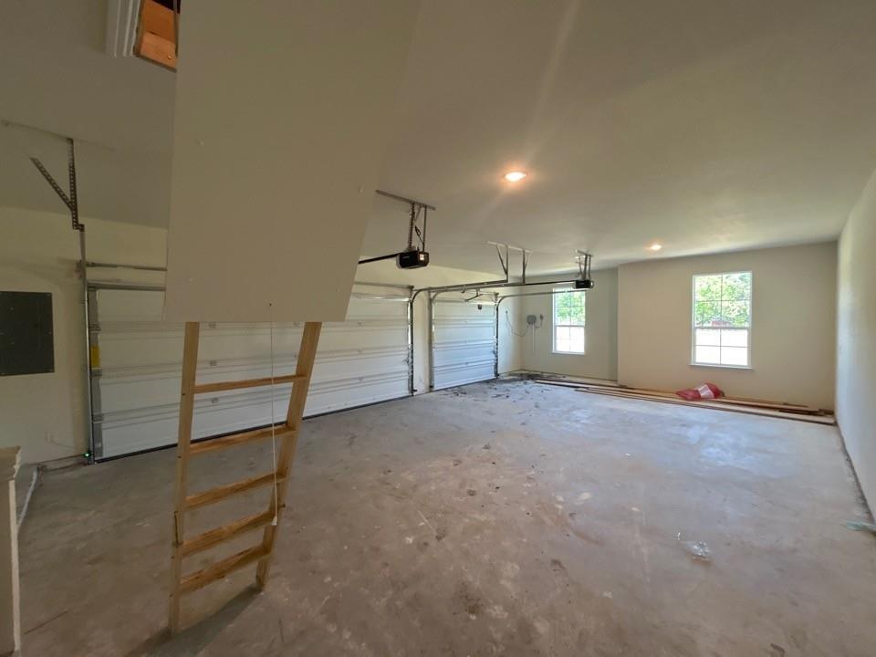 8813 County Road 623 Blue Ridge, TX 75424 - Photo 16 of 19 Spacious garage with concrete flooring, two garage doors, two windows, recessed lighting, and an attic access ladder