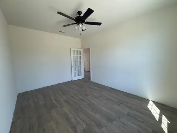 an empty room with windows and closet