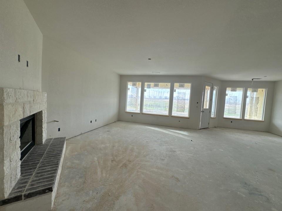 8813 County Road 623 Blue Ridge, TX 75424 - Photo 8 of 20 a view of an empty room with a fireplace and a window