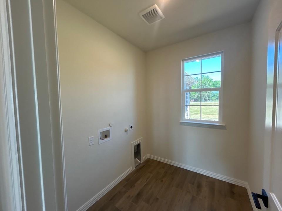 8813 County Road 623 Blue Ridge, TX 75424 - Photo 9 of 19 Utility room featuring wood-finish flooring, a window with exterior visibility, light-toned walls, and a ceiling-mounted ventilation system