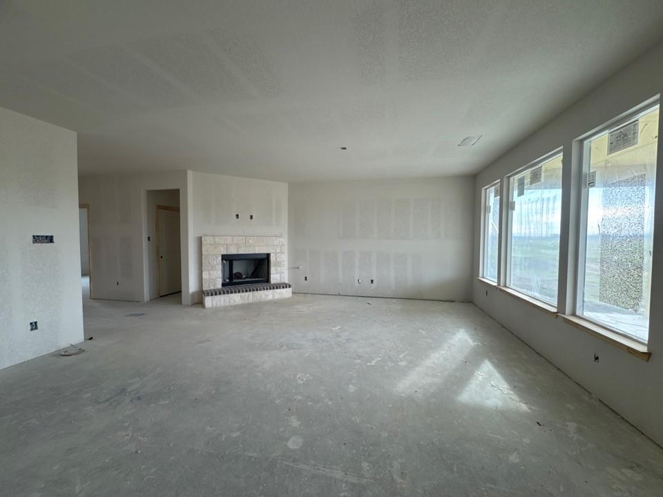 8813 County Road 623 Blue Ridge, TX 75424 - Photo 9 of 20 an empty room with a fireplace and a window