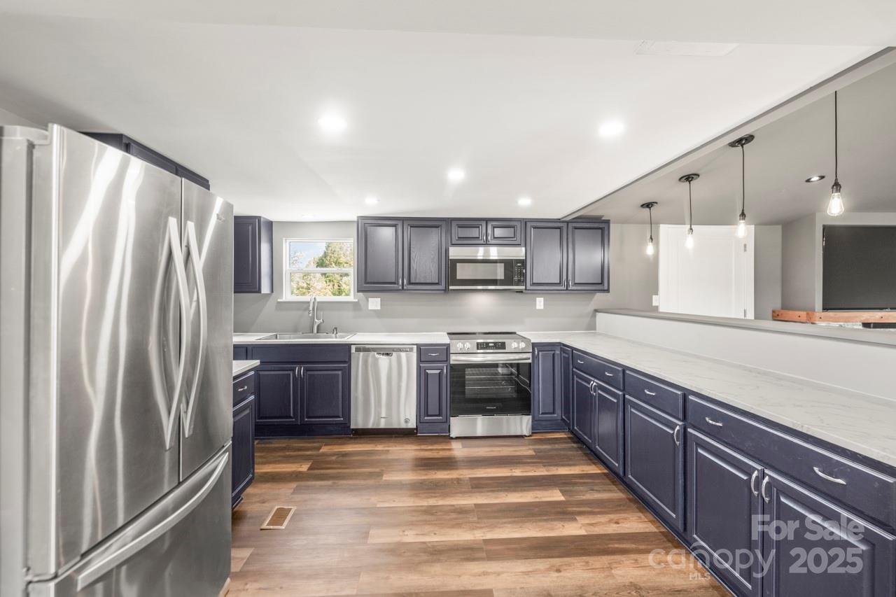 5354 Sherrills Ford Road Catawba, NC 28609 - Photo 11 of 44 a large kitchen with stainless steel appliances lots of counter space and a sink