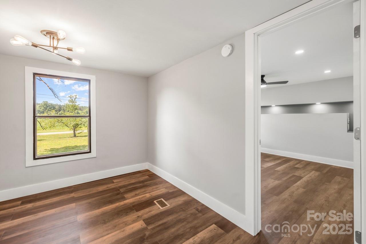 5354 Sherrills Ford Road Catawba, NC 28609 - Photo 18 of 44 a view of empty room with wooden floor and fan