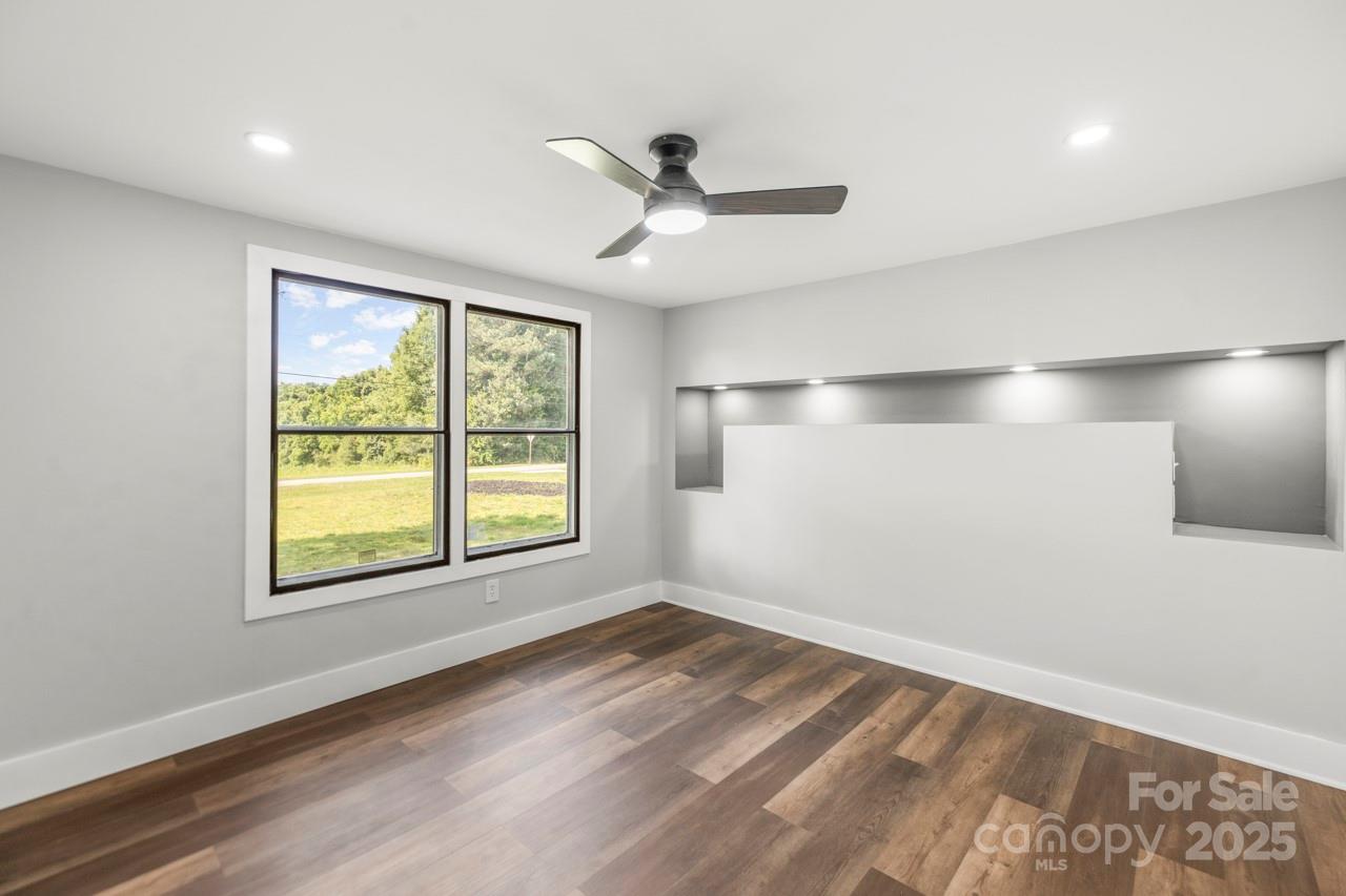 5354 Sherrills Ford Road Catawba, NC 28609 - Photo 21 of 44 a view of an empty room with wooden floor and a window