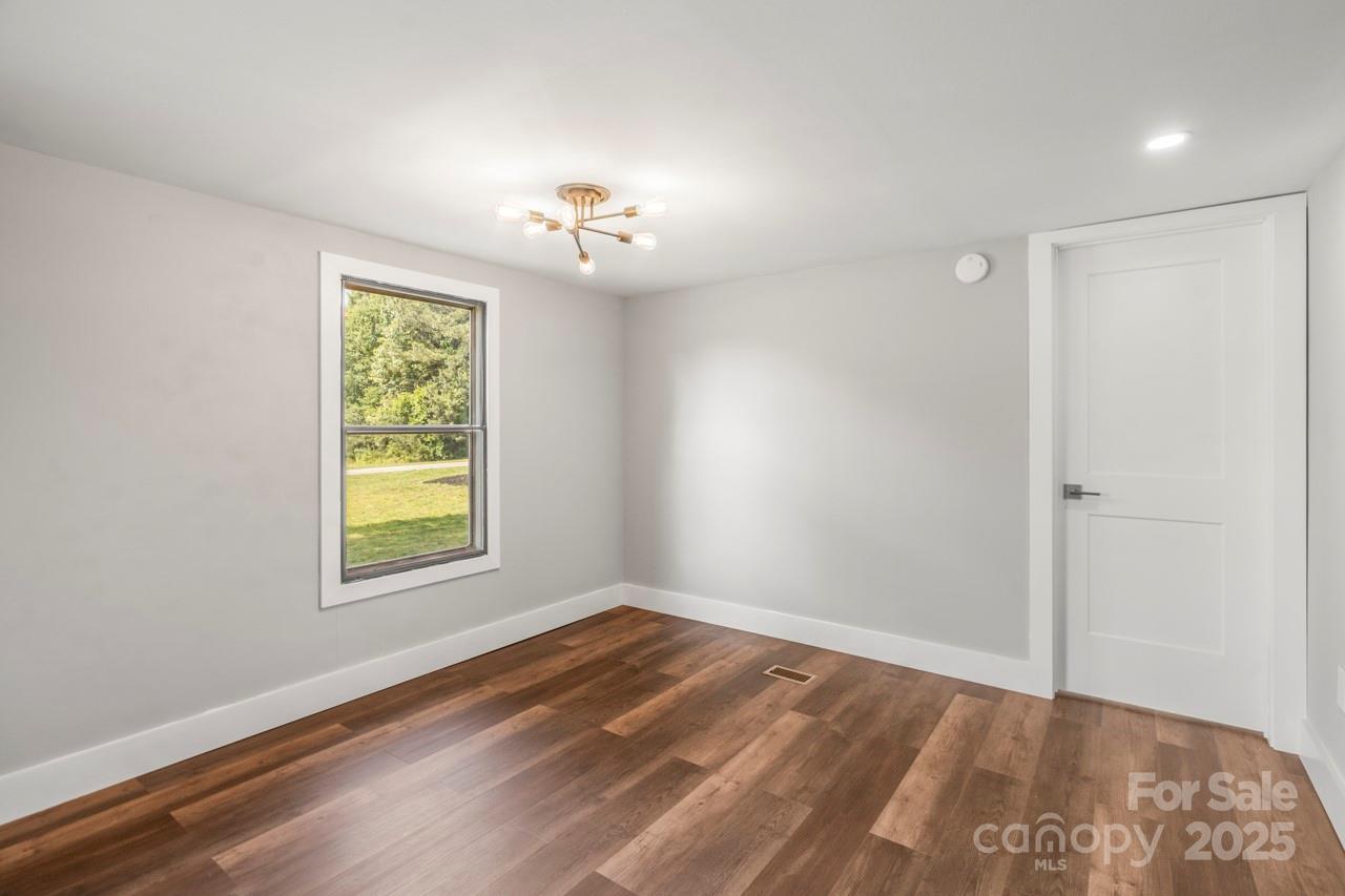5354 Sherrills Ford Road Catawba, NC 28609 - Photo 7 of 44 wooden floor in an empty room with a window