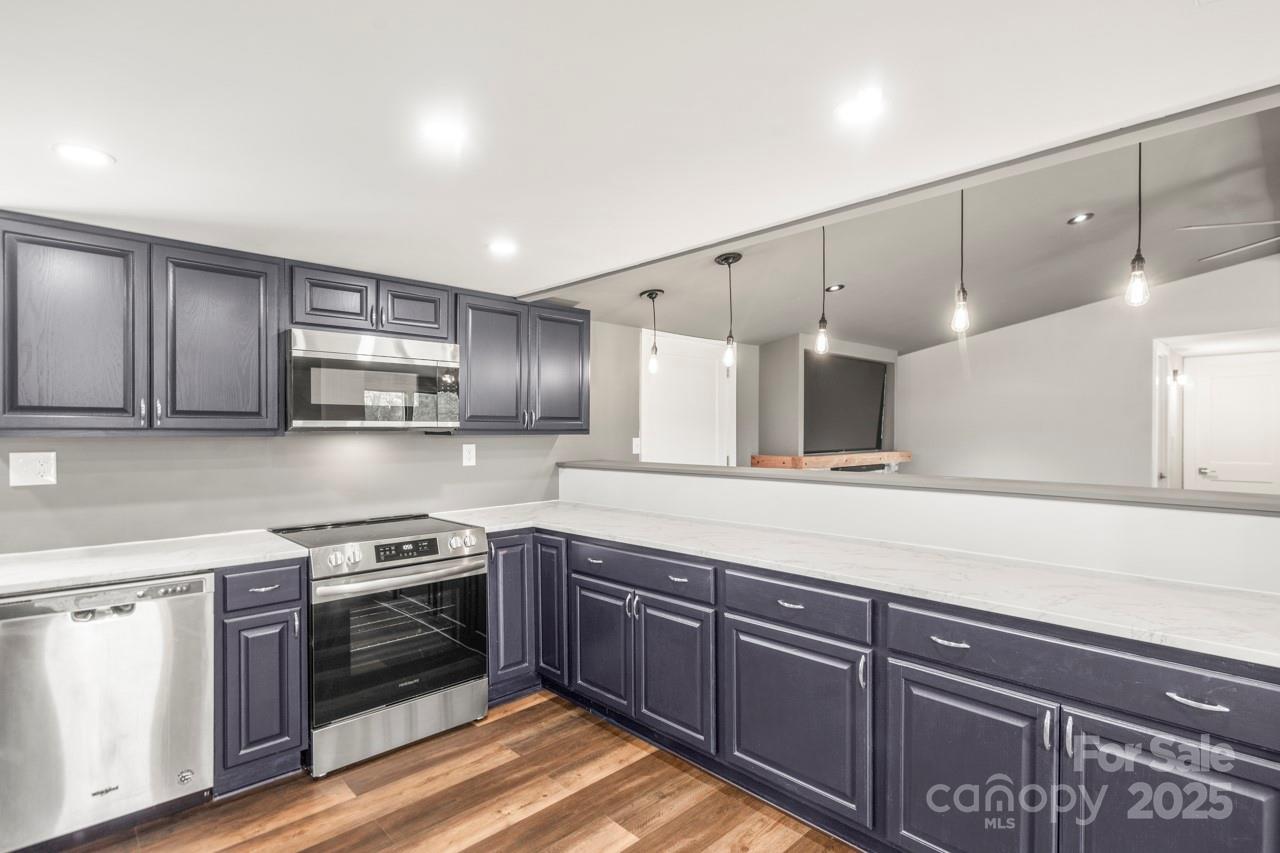 5354 Sherrills Ford Road Catawba, NC 28609 - Photo 8 of 44 a kitchen with stainless steel appliances granite countertop a stove a sink and a refrigerator