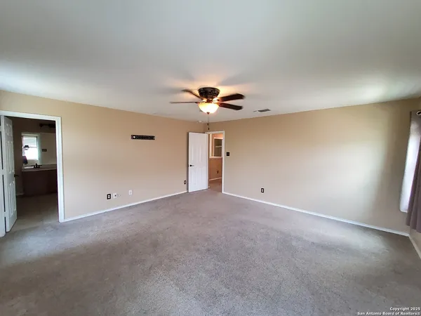 a view of a livingroom with a ceiling fan and window