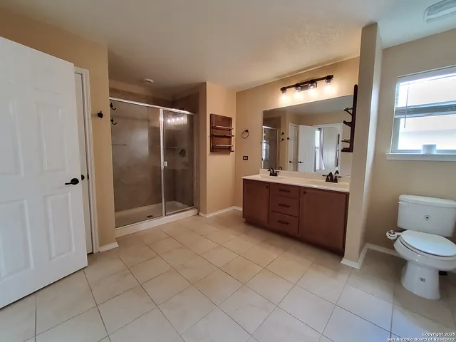 a bathroom with a double vanity sink mirror and toilet