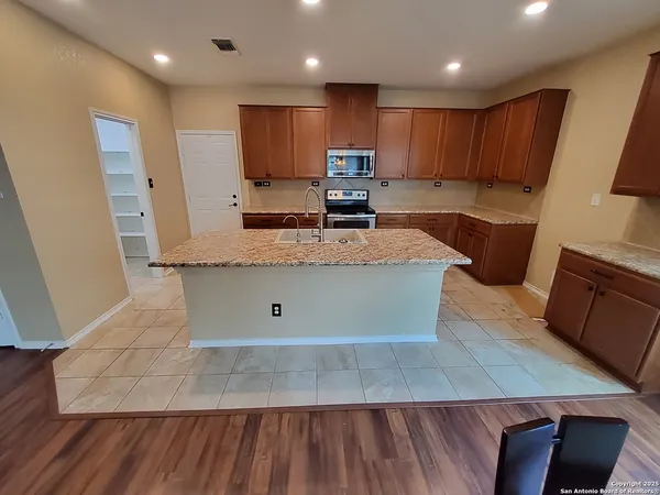 a large kitchen with wooden floor