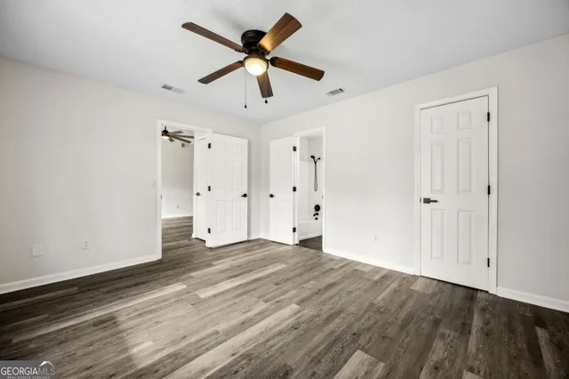 a view of wooden floor and closet area