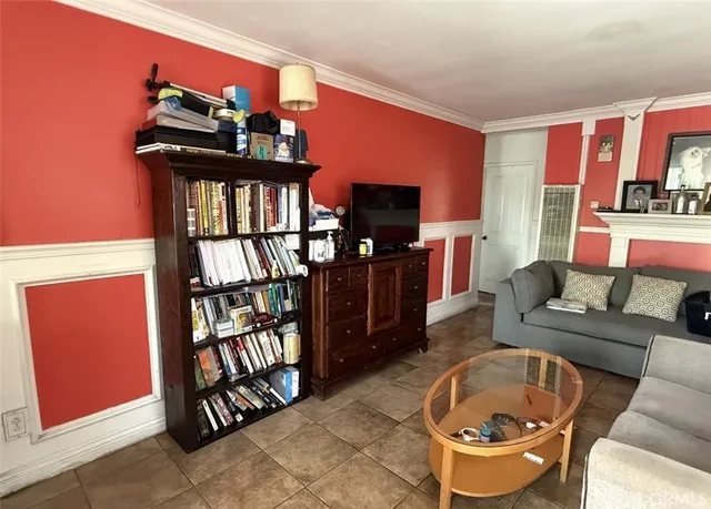 a living room with furniture a flat screen tv and a window