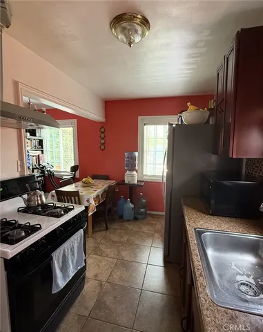 a kitchen with a stove a sink and a refrigerator