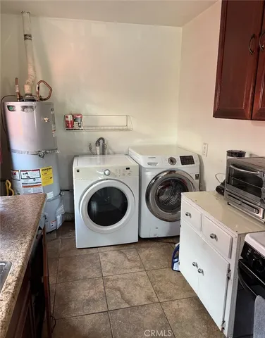 a utility room with sink dryer and washer