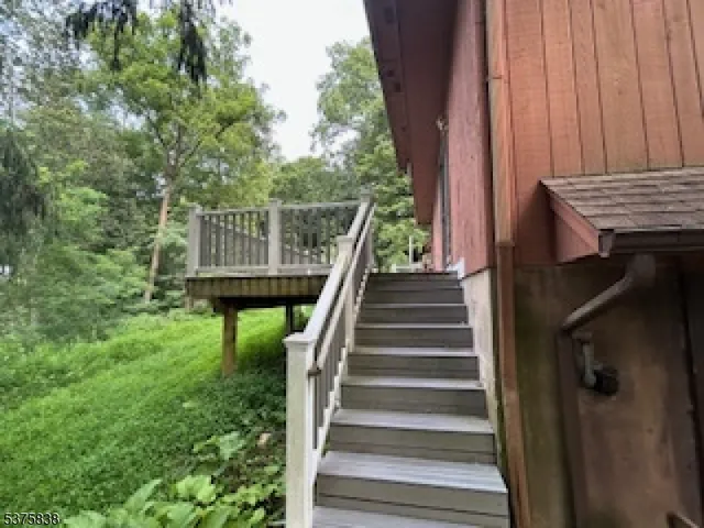 a view of balcony with wooden floor and outdoor seating