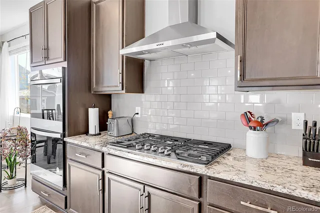 a kitchen with a stove and a white cabinets
