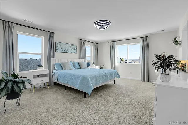 a bedroom with a bed and a chair