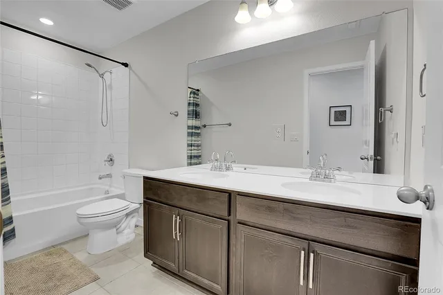 a white toilet sitting next to a bathroom sink