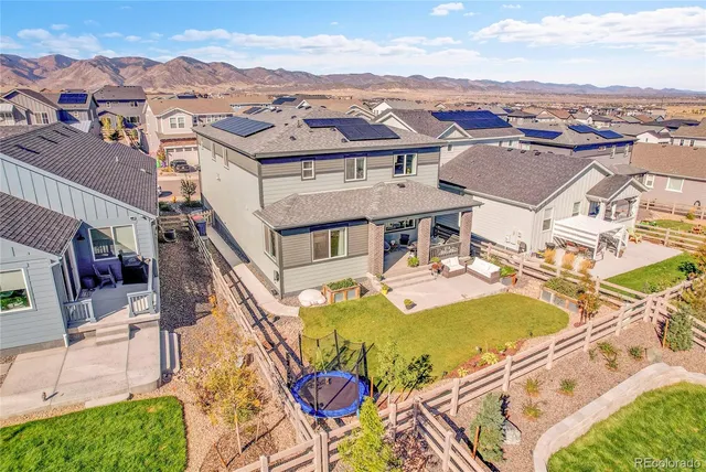 a view of a brick house with a big yard and large trees