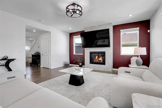 a living room with furniture flat screen tv and a fireplace