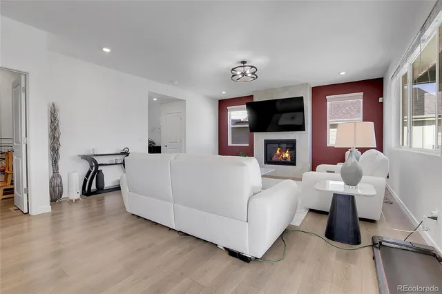 a living room with furniture flat screen tv and a fireplace