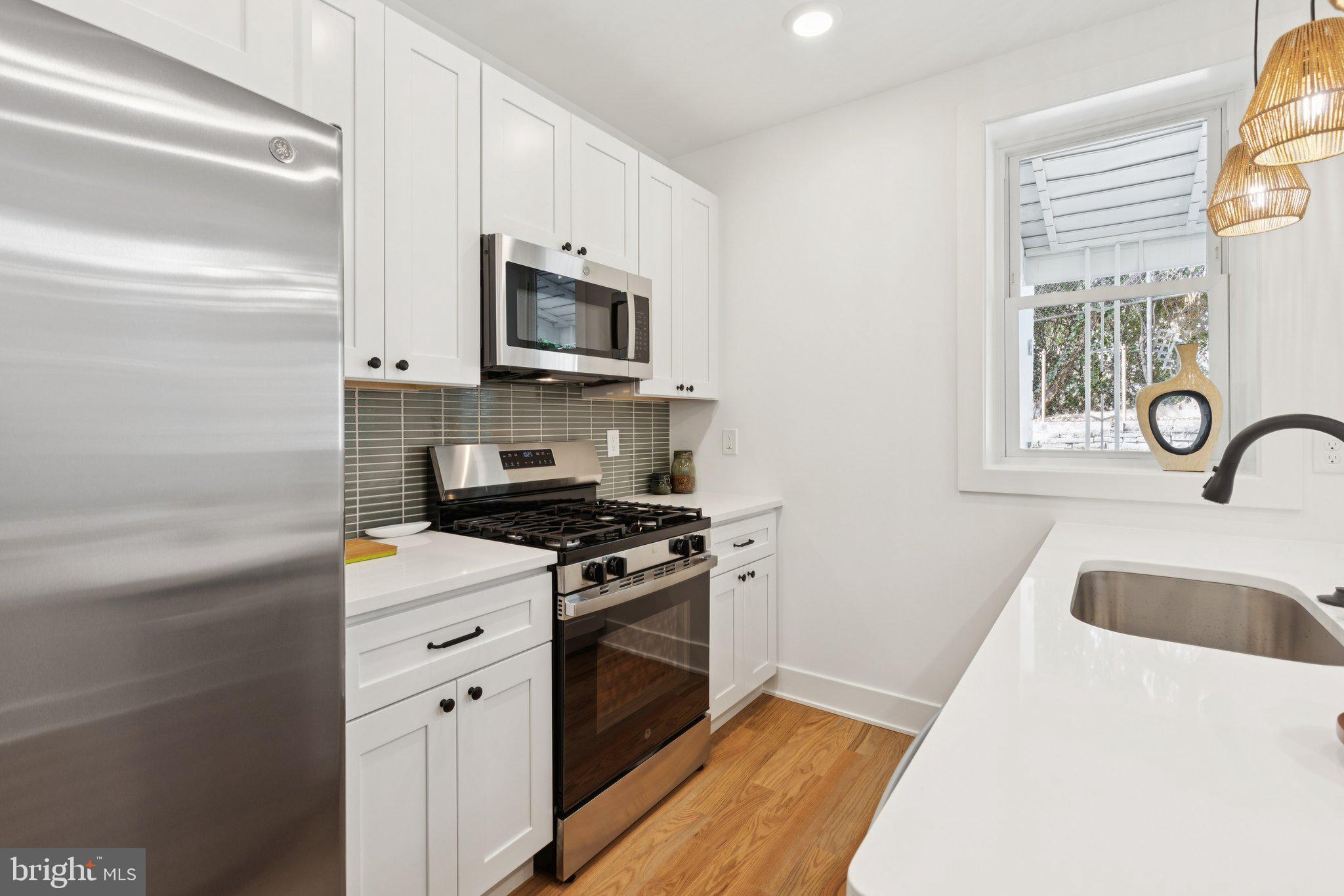 3697 Calumet Street Philadelphia, PA 19129 - Photo 13 of 34 a kitchen with stainless steel appliances granite countertop a sink and a stove