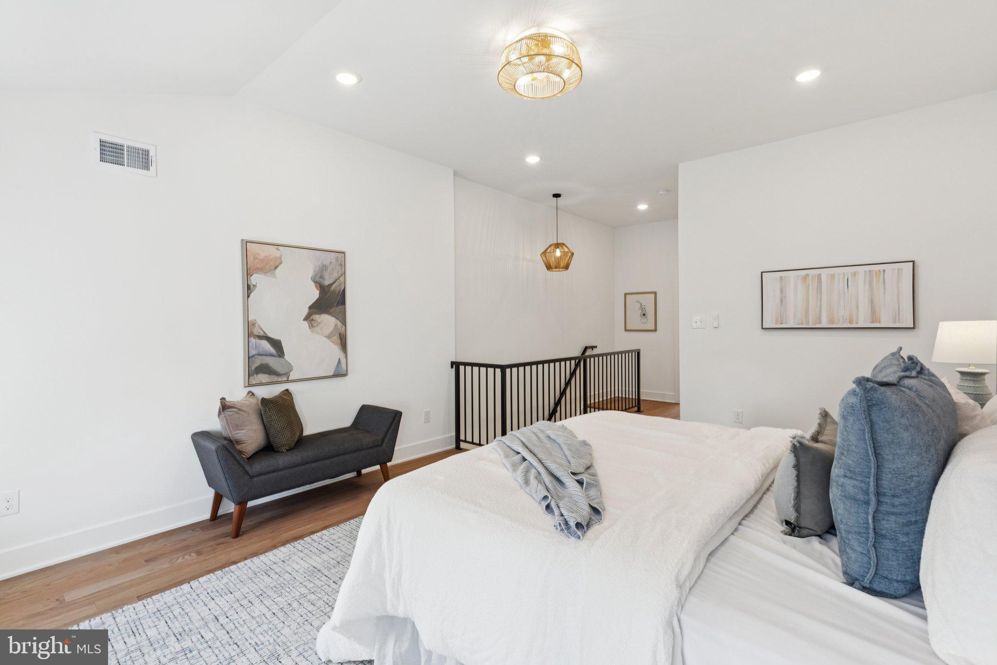 3697 Calumet Street Philadelphia, PA 19129 - Photo 19 of 34 a bed room with a bed mirror and a couch