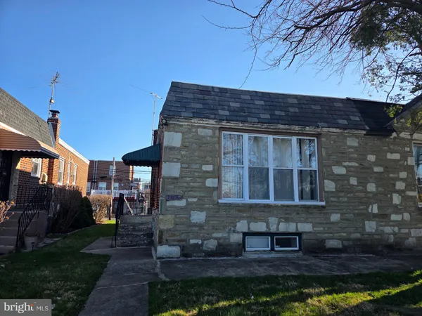 a brick building with a bench in front of it