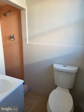 a white toilet sitting next to a bathroom sink
