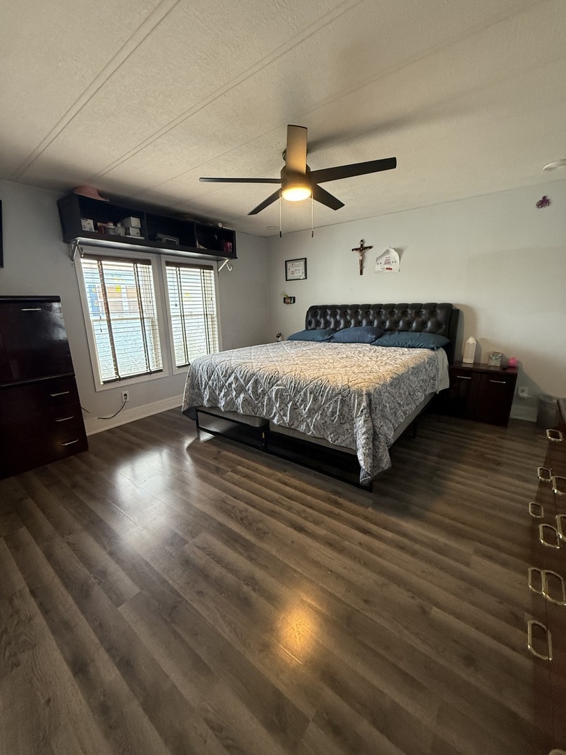 588 Hickory Glen Road Matteson, IL 60443 - Photo 36 of 50 a spacious bedroom with a bed and wooden floors