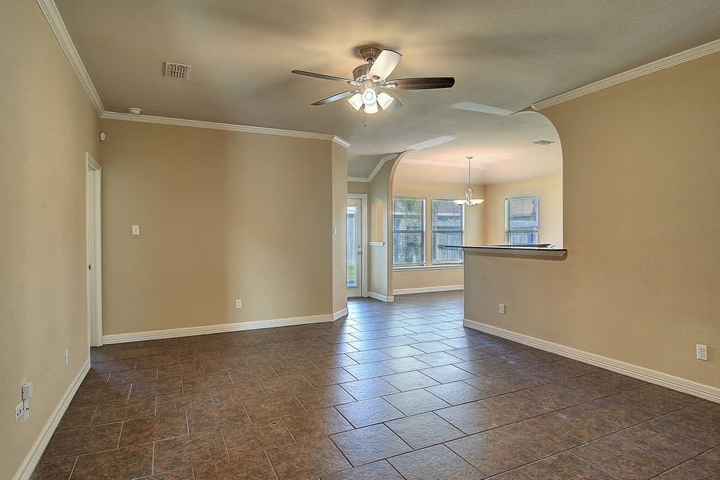 6824 Fox Tail Drive Corpus Christi, TX 78413 - Photo 12 of 40 a view of an empty room with a ceiling fan
