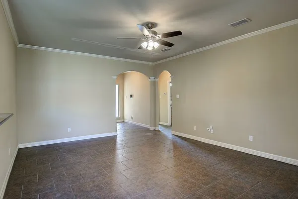 an empty room with fan and entrance