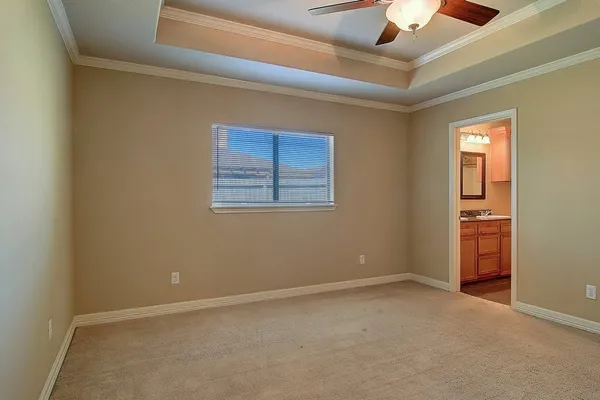 an empty room with a ceiling fan and a window