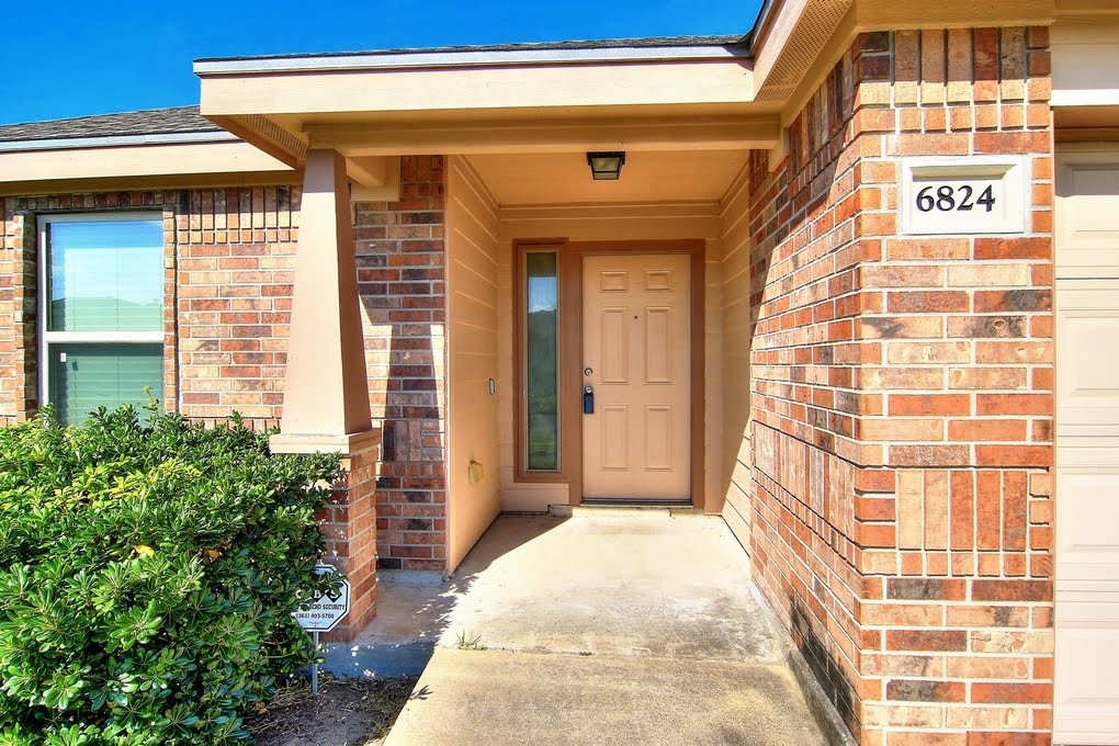 6824 Fox Tail Drive Corpus Christi, TX 78413 - Photo 2 of 40 a view of entryway with a flower garden
