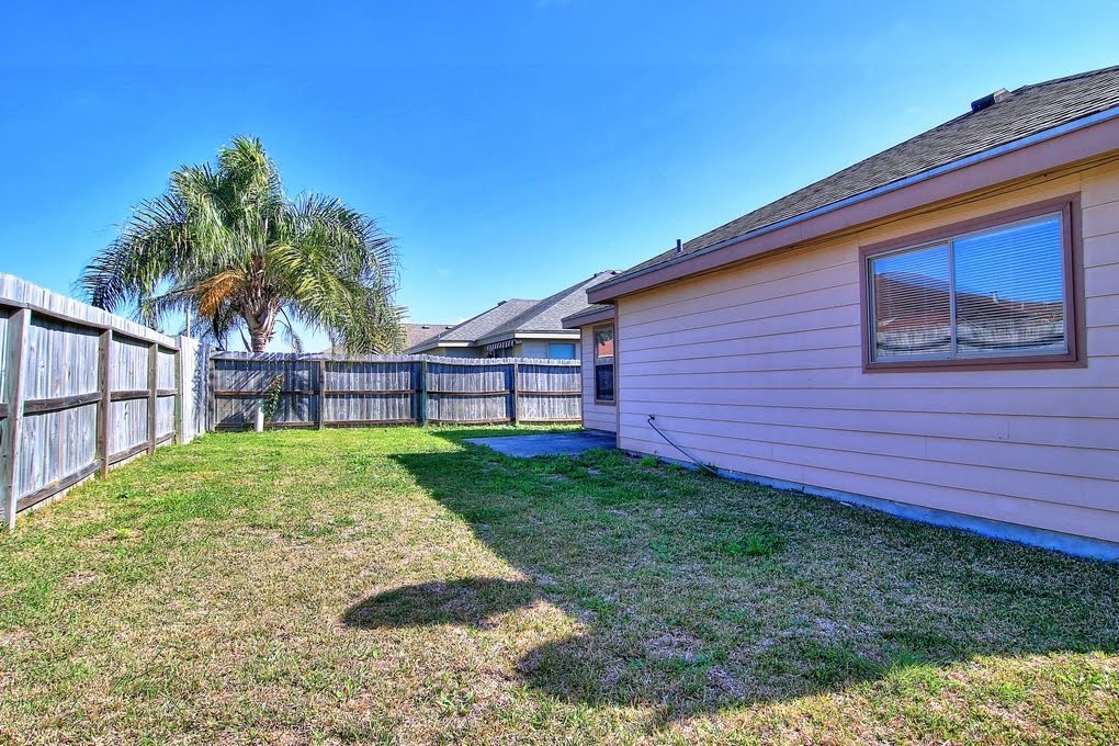6824 Fox Tail Drive Corpus Christi, TX 78413 - Photo 30 of 40 a view of backyard with potted plants and wooden fence