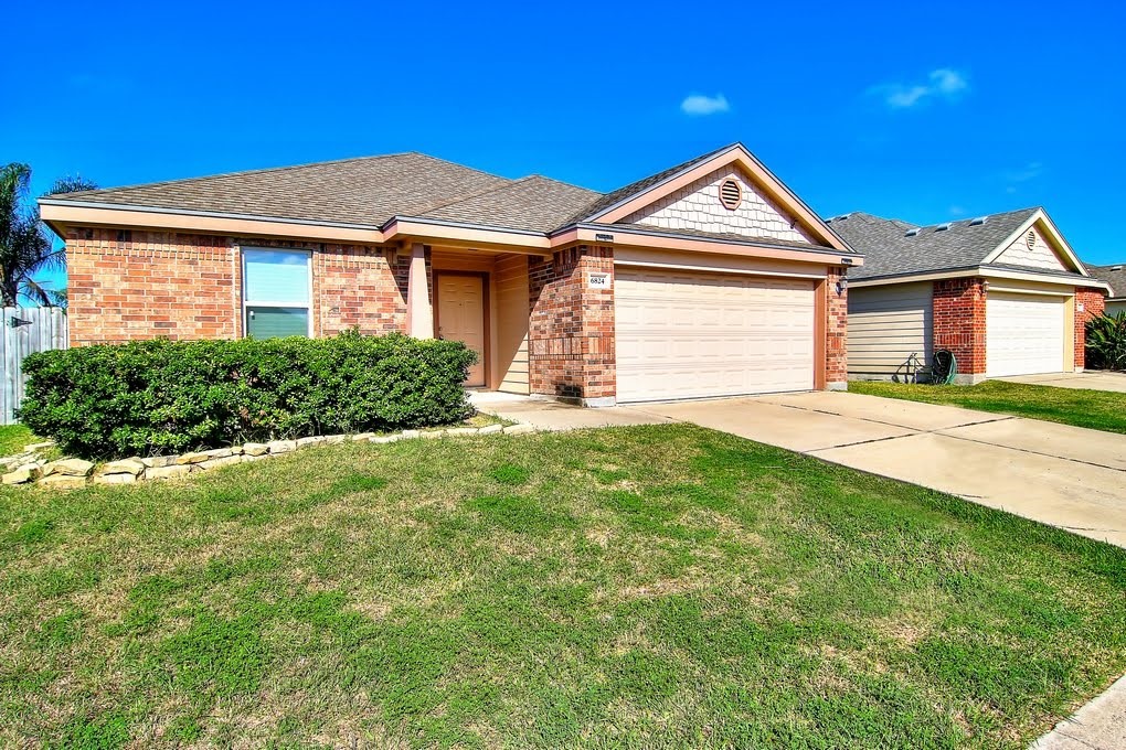 6824 Fox Tail Drive Corpus Christi, TX 78413 - Photo 38 of 40 a front view of a house with a yard and garage