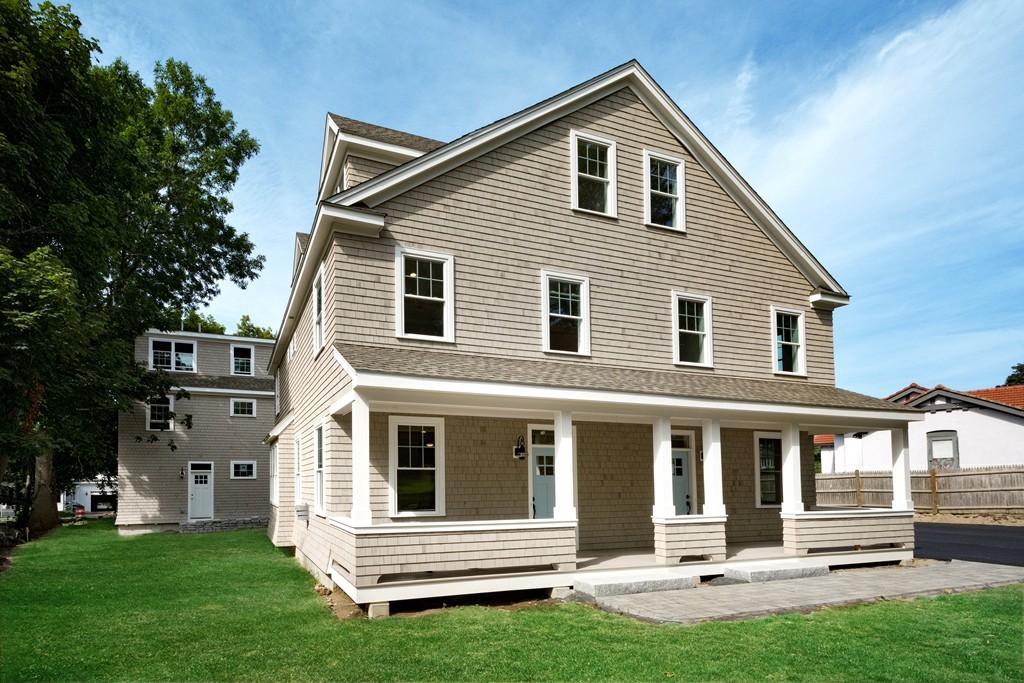 95 First Parish Road, Unit 1 Scituate, MA 02066 - Photo 1 of 24 a front view of a house with a yard