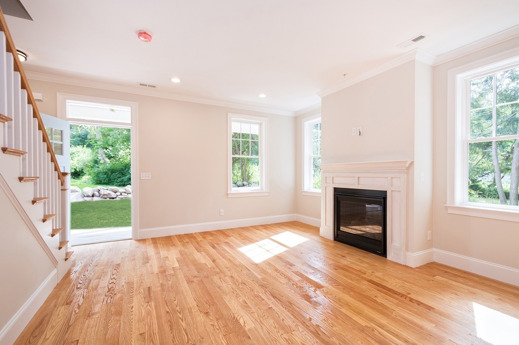 95 First Parish Road, Unit 1 Scituate, MA 02066 - Photo 12 of 24 a view of empty room with a fireplace and wooden floor