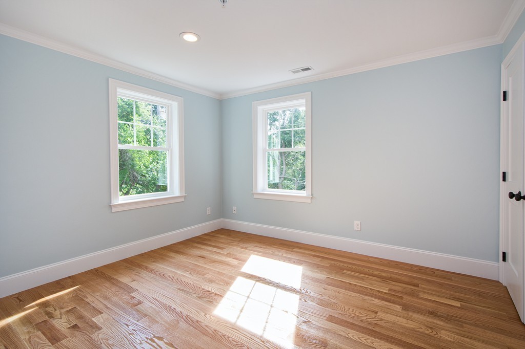 95 First Parish Road, Unit 1 Scituate, MA 02066 - Photo 14 of 24 a view of an empty room with wooden floor and a window
