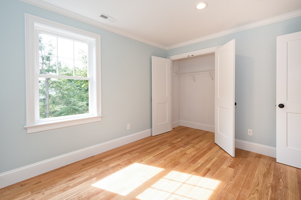 95 First Parish Road, Unit 1 Scituate, MA 02066 - Photo 15 of 24 a view of empty room with wooden floor and fan