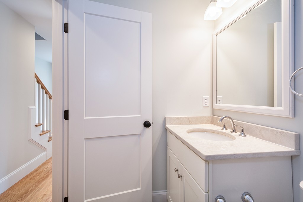 95 First Parish Road, Unit 1 Scituate, MA 02066 - Photo 18 of 24 a bathroom with a sink and a mirror