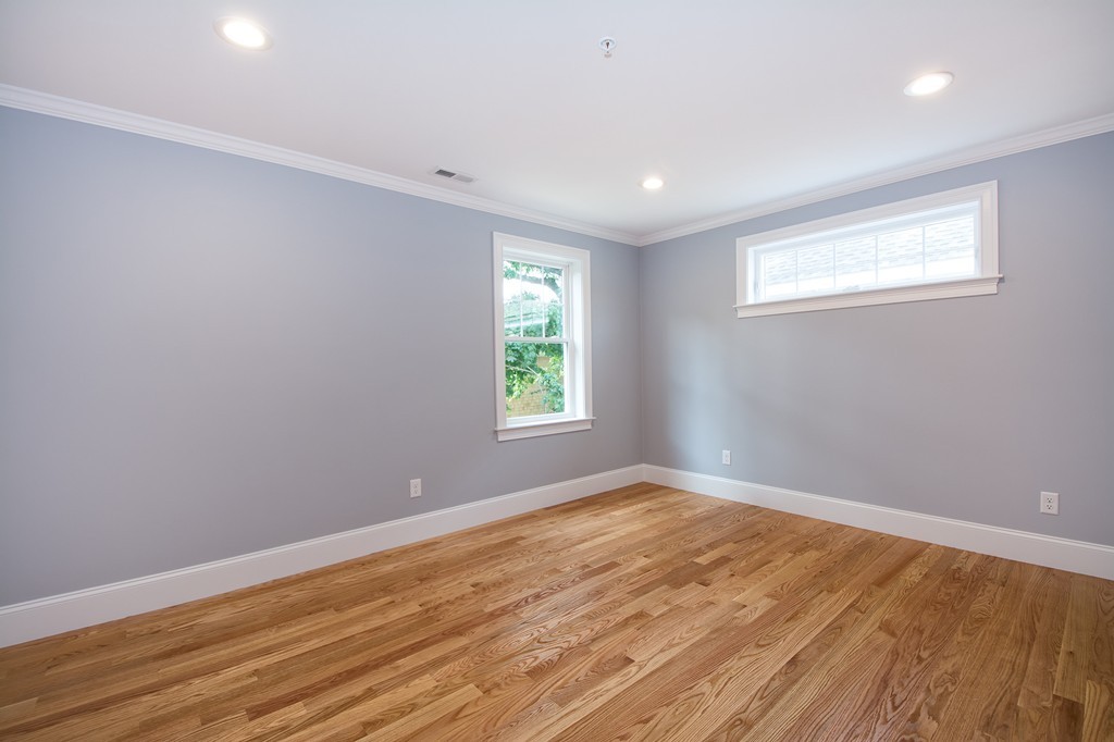 95 First Parish Road, Unit 1 Scituate, MA 02066 - Photo 19 of 24 a view of empty room with wooden floor and fan