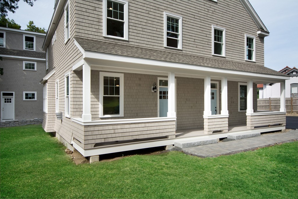 95 First Parish Road, Unit 1 Scituate, MA 02066 - Photo 3 of 24 a front view of a house with a yard