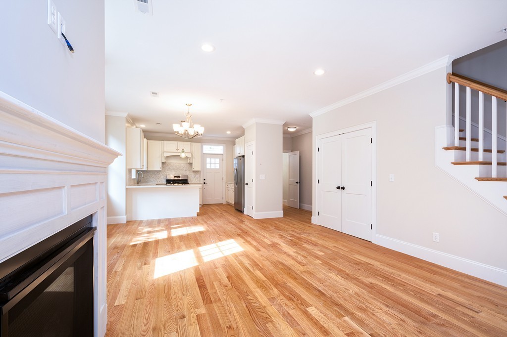 95 First Parish Road, Unit 1 Scituate, MA 02066 - Photo 8 of 24 a view of a kitchen with kitchen island wooden floor and stainless steel appliances