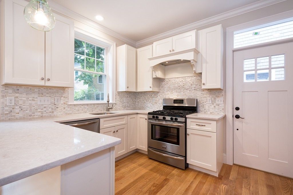 95 First Parish Road, Unit 1 Scituate, MA 02066 - Photo 10 of 24 a kitchen with a stove a sink and a microwave